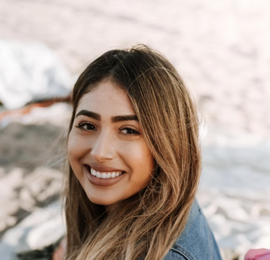 Smiling woman with long hair in natural light